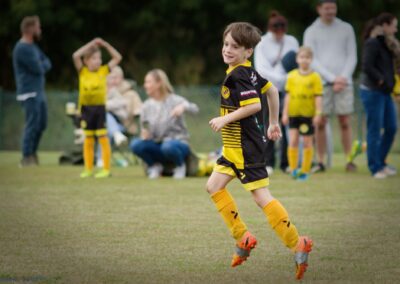 boy running across the soccer fields