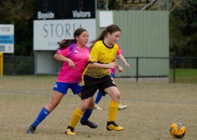 girls chasing after football